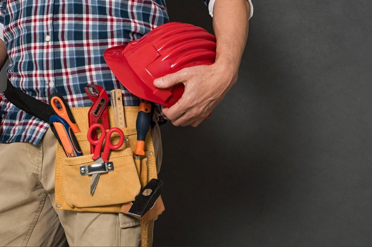 Handyman with a tool belt ready for home maintenance work in a Dubai apartment